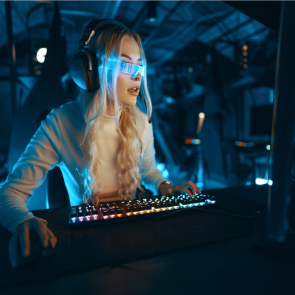 Blonde in cyberpunk glasses plays computer games, fascinated by technology and the virtual world.